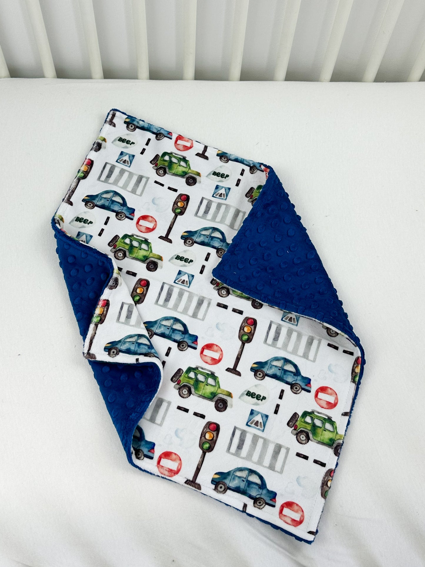a close up of a baby bib on a bed