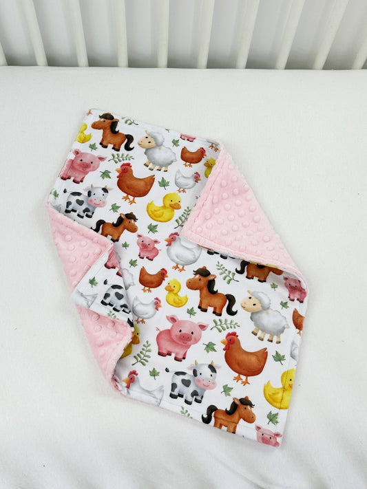 a white crib with farm animals and farm animals on it