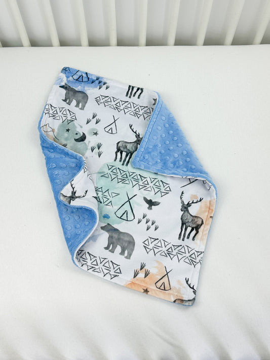 a close up of a baby's bib on a bed
