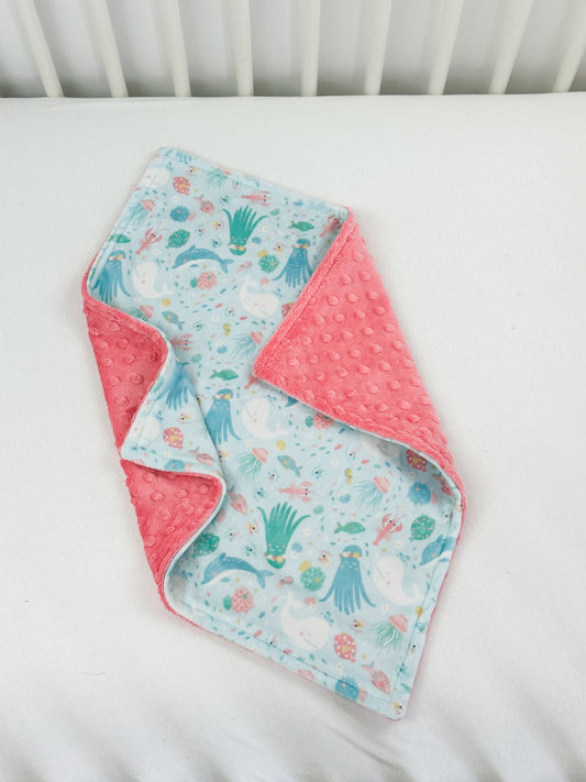 a close up of a blanket on a bed