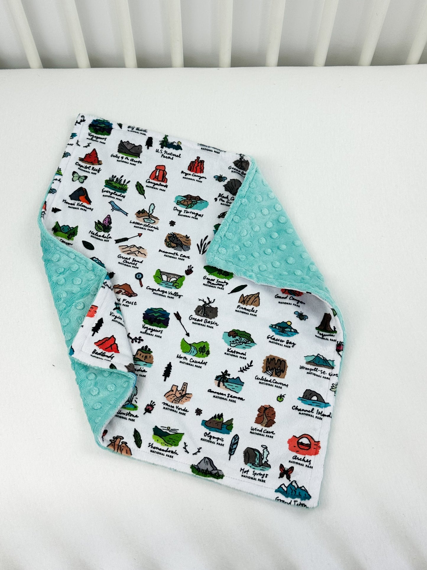 a white crib with a baby's bib on it