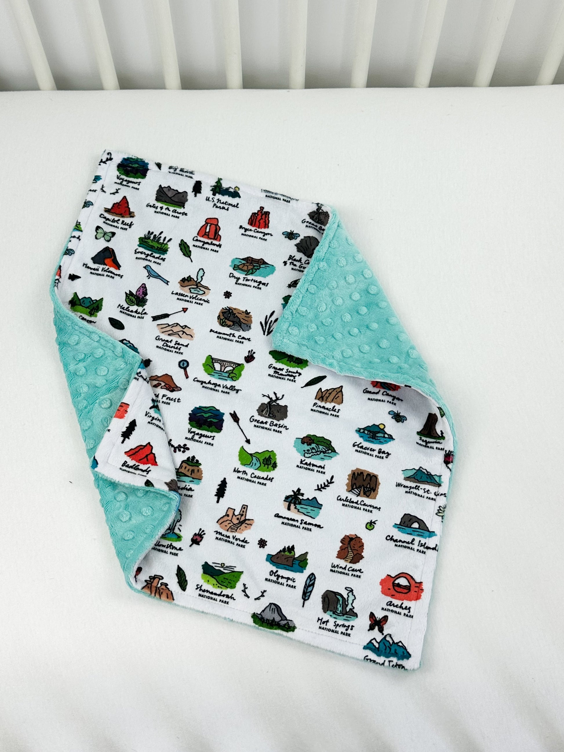 a white crib with a baby's bib on it