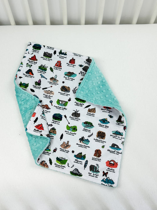 a white crib with a baby's bib on it