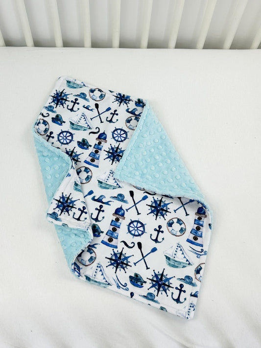 a close up of a baby bib on a bed