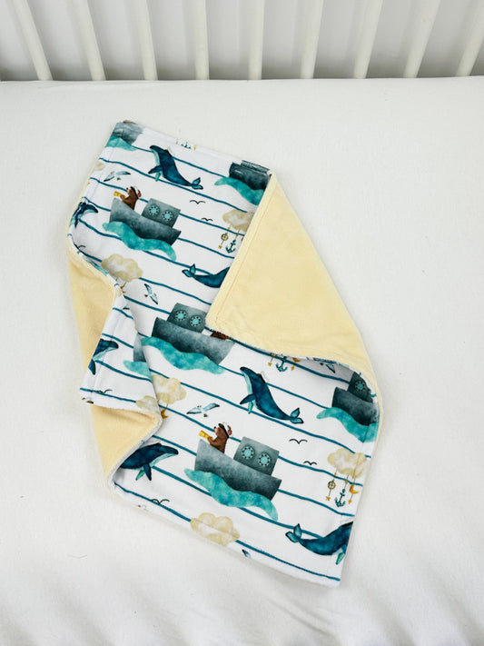 a baby bib and burple laying on a bed