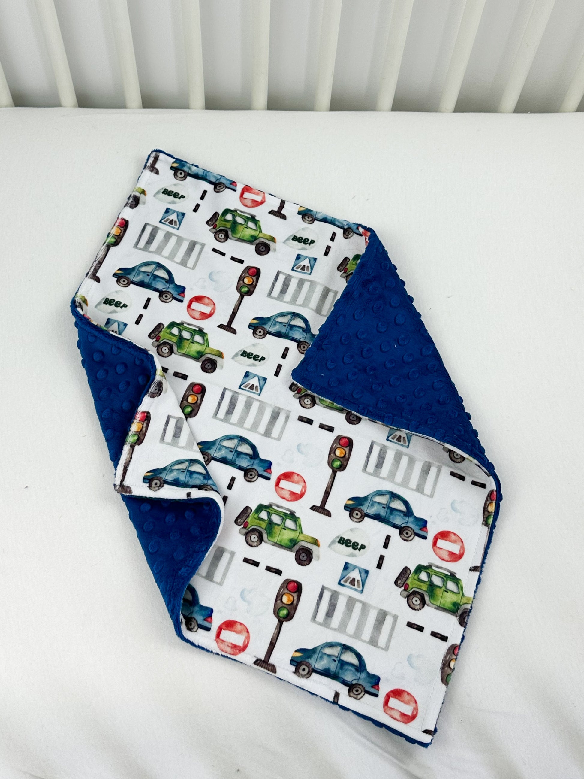 a close up of a baby bib on a bed