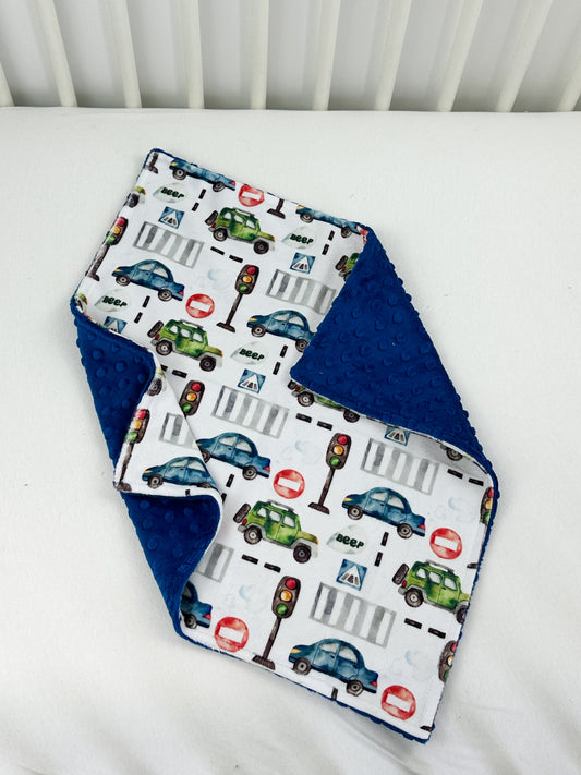 a close up of a baby bib on a bed