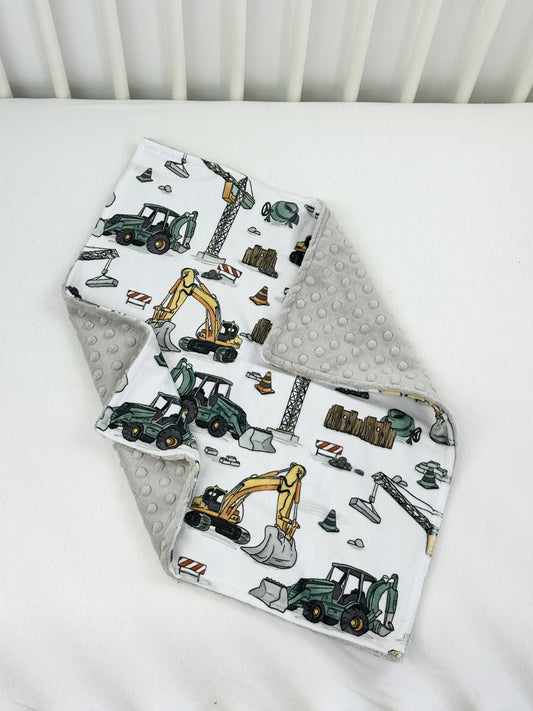 a baby bib with construction vehicles on it