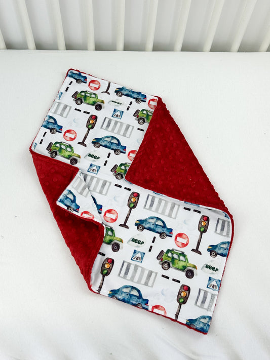 a close up of a baby bib on a bed