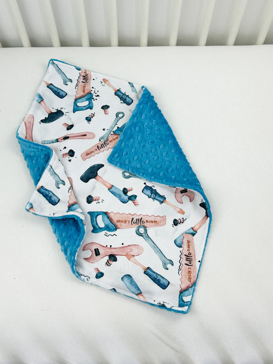 a baby's bib laying on top of a white crib